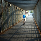 Bicyclist and Shadows on Bridge